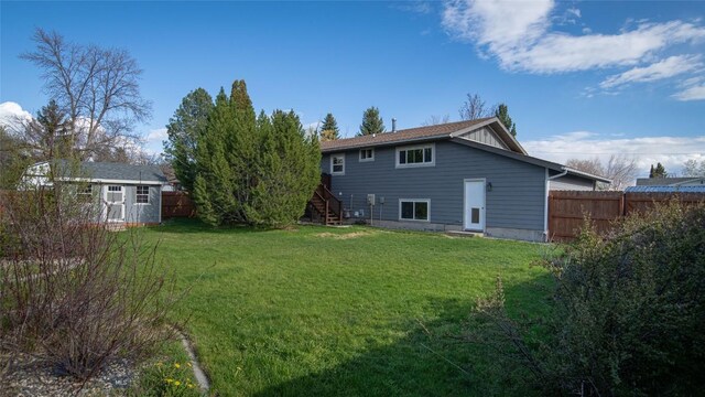 417 Henry Dr, Belgrade, MT 59714 - rear view of property featuring a storage shed, an outdoor structure, fence, and stairs