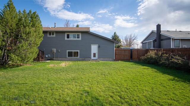 417 Henry Dr, Belgrade, MT 59714 - back of property featuring a yard, fence, and entry steps