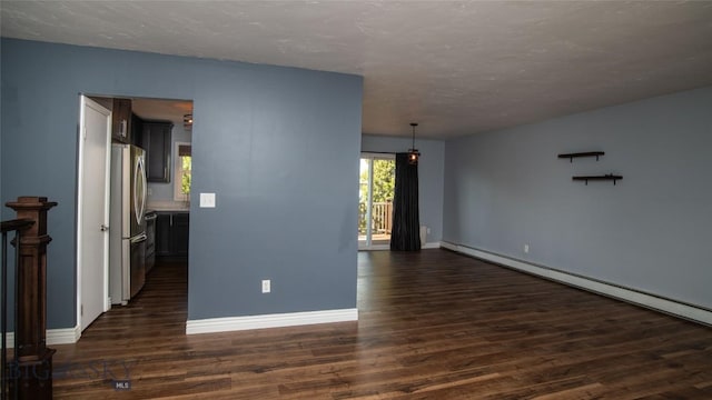 417 Henry Dr, Belgrade, MT 59714 - empty room featuring a baseboard radiator, dark wood-type flooring, and a textured ceiling