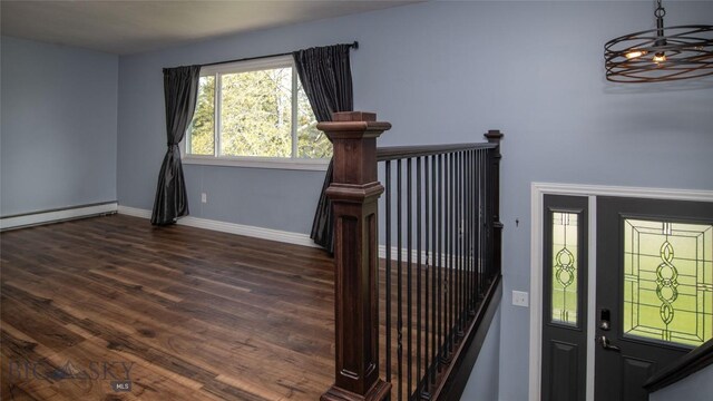 417 Henry Dr, Belgrade, MT 59714 - staircase featuring an inviting chandelier, baseboards, a baseboard heating unit, and wood finished floors
