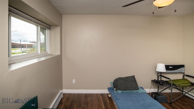 417 Henry Dr, Belgrade, MT 59714 - exercise area with wood finished floors, a ceiling fan, baseboards, and a baseboard heating unit
