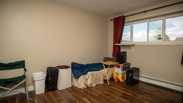 417 Henry Dr, Belgrade, MT 59714 - bedroom featuring a baseboard heating unit and wood finished floors
