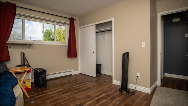 417 Henry Dr, Belgrade, MT 59714 - unfurnished bedroom featuring baseboard heating, dark wood-type flooring, and a closet