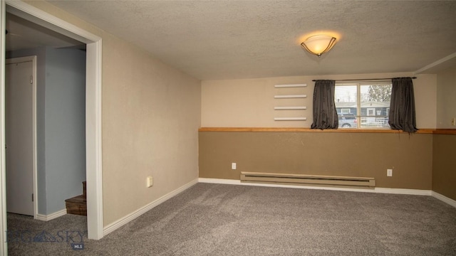 417 Henry Dr, Belgrade, MT 59714 - carpeted empty room with baseboards, a baseboard radiator, and a textured ceiling