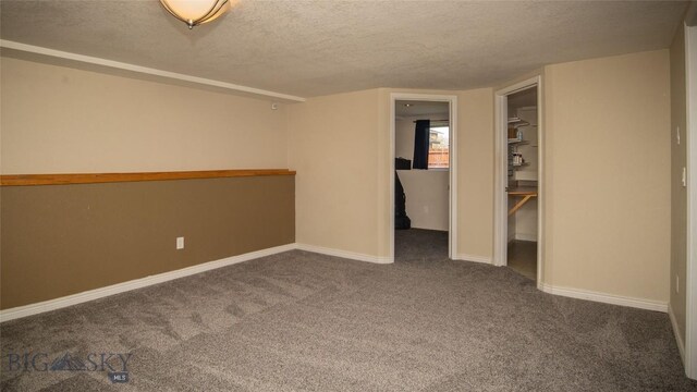 417 Henry Dr, Belgrade, MT 59714 - unfurnished bedroom with carpet floors, baseboards, and a textured ceiling