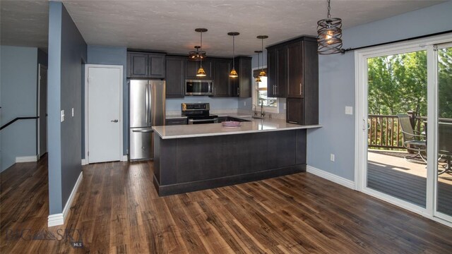 417 Henry Dr, Belgrade, MT 59714 - kitchen with appliances with stainless steel finishes, a sink, light countertops, a peninsula, and baseboards