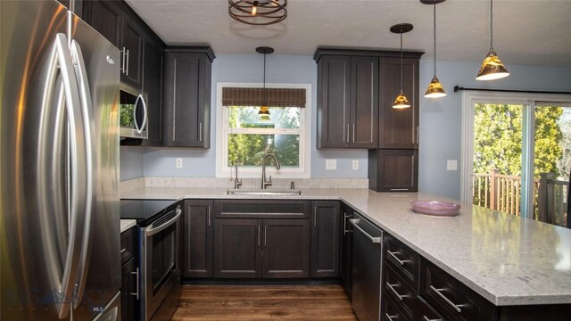 417 Henry Dr, Belgrade, MT 59714 - kitchen featuring stainless steel appliances, a peninsula, plenty of natural light, and dark wood finished floors