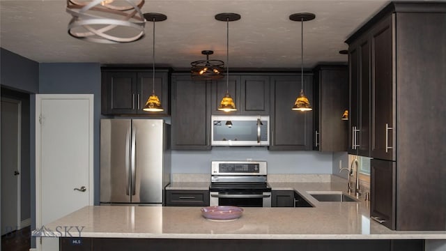 417 Henry Dr, Belgrade, MT 59714 - kitchen with stainless steel appliances, light stone countertops, a peninsula, and pendant lighting