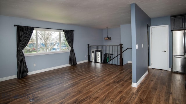 417 Henry Dr, Belgrade, MT 59714 - empty room featuring baseboards and dark wood-style floors