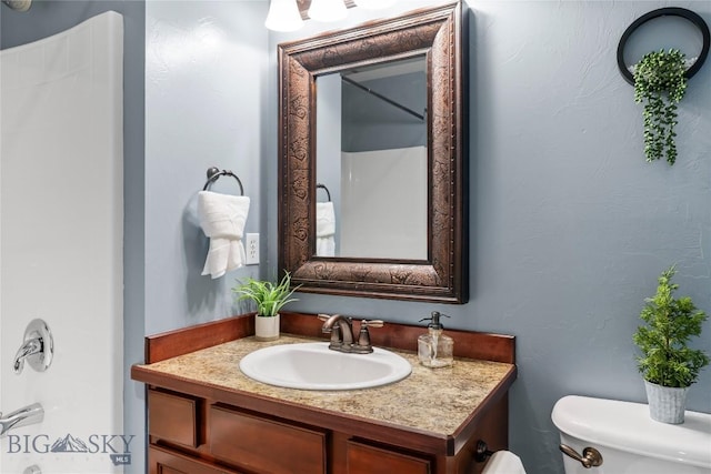 bathroom with toilet and vanity