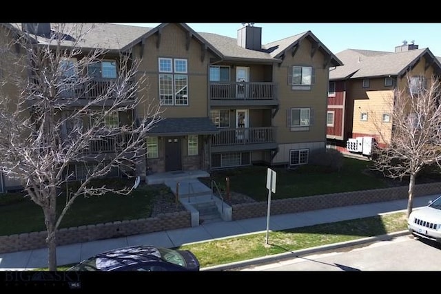 4635 Bembrick St Unit 1B, Bozeman, MT 59718 - view of front facade featuring cooling unit, a chimney, and a front yard