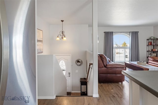 entryway featuring a chandelier and wood finished floors