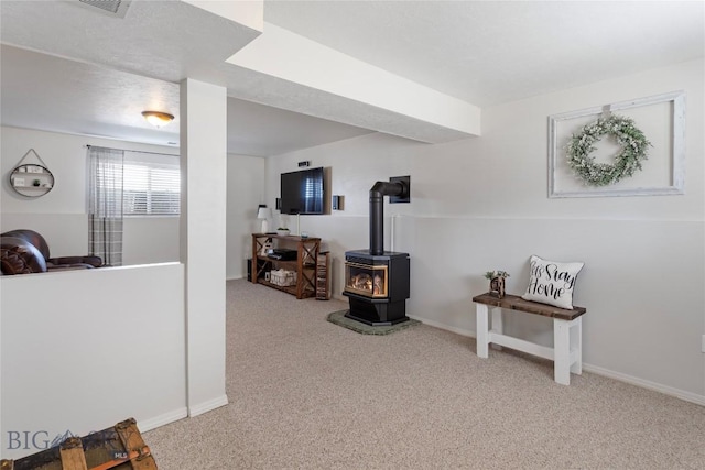 interior space featuring carpet flooring, baseboards, and visible vents