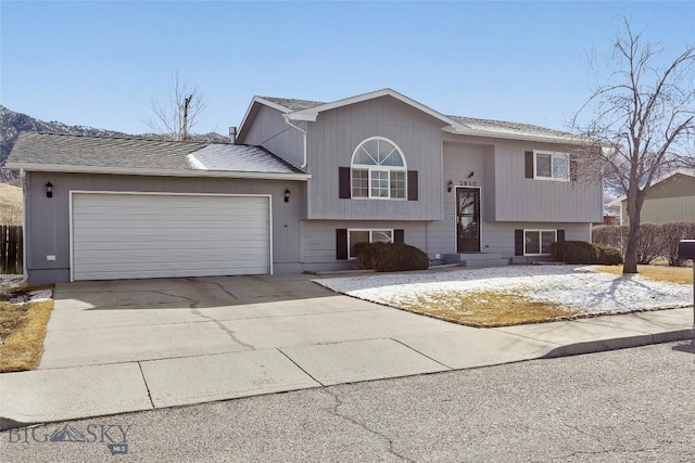 raised ranch with a garage and driveway