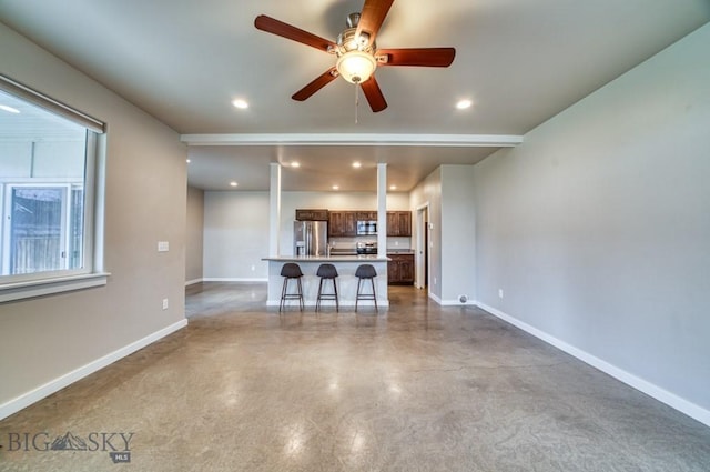 unfurnished living room with finished concrete flooring, baseboards, ceiling fan, and recessed lighting
