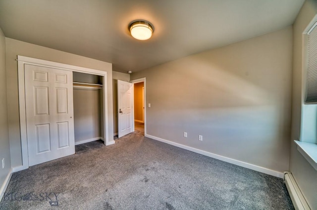 unfurnished bedroom featuring a closet, carpet floors, baseboards, and a baseboard heating unit