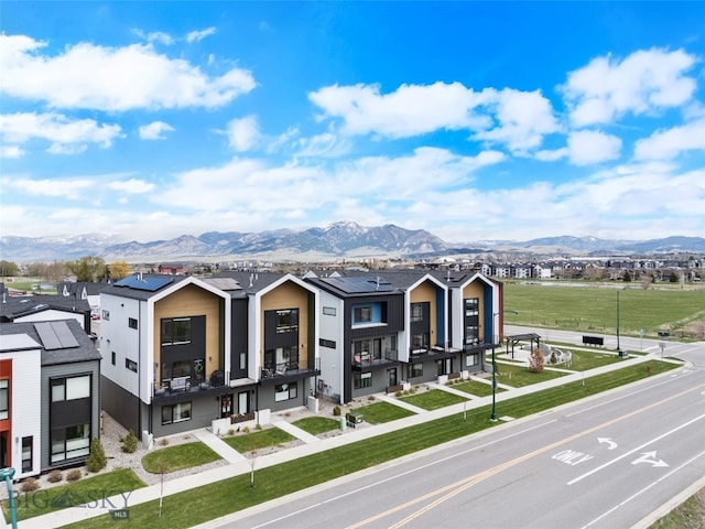 view of front of property featuring a mountain view and a residential view