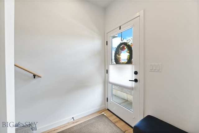 doorway to outside featuring light wood-style floors and baseboards