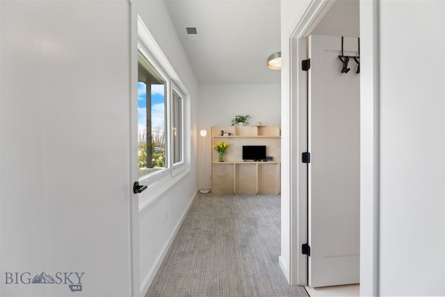 corridor featuring carpet, visible vents, and baseboards