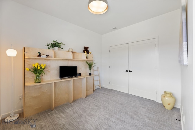 interior space with baseboards and light colored carpet