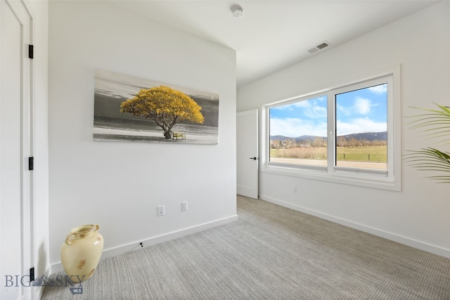 unfurnished room with visible vents, baseboards, and carpet floors