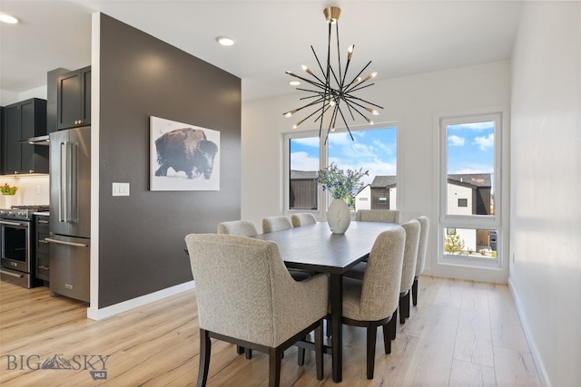 dining space with an inviting chandelier, baseboards, recessed lighting, and light wood-type flooring