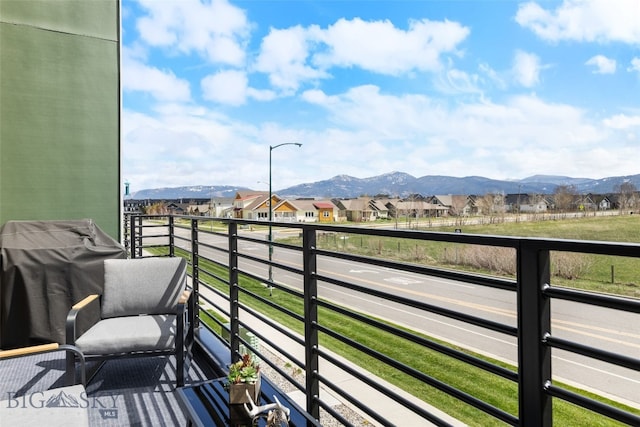 balcony featuring a mountain view and a residential view