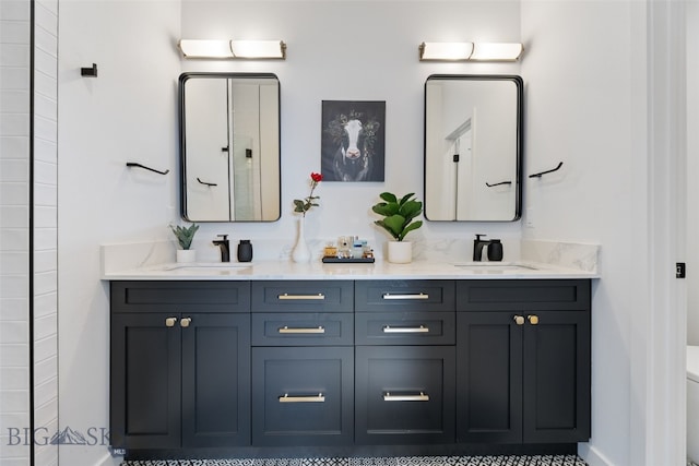 bathroom featuring a sink, double vanity, and toilet