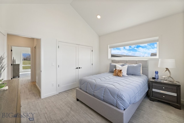 bedroom featuring high vaulted ceiling, a closet, baseboards, light carpet, and recessed lighting