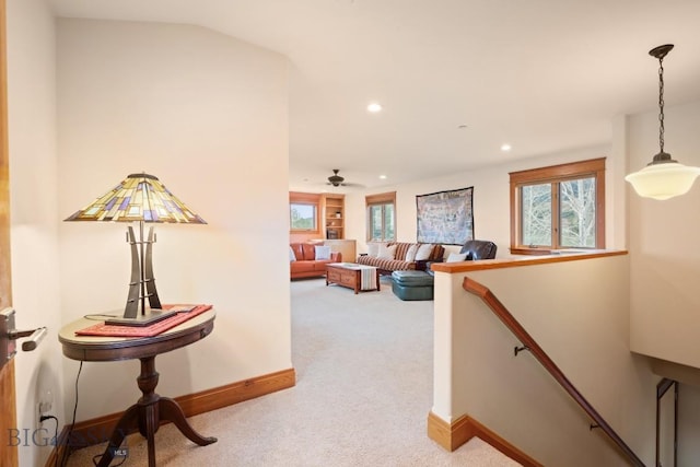 hall featuring baseboards, carpet, recessed lighting, and an upstairs landing