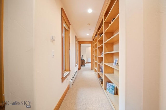 corridor with light carpet, baseboard heating, built in shelves, recessed lighting, and baseboards