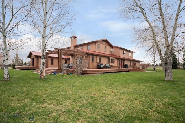 rear view of house with a pergola, a chimney, a yard, and a deck