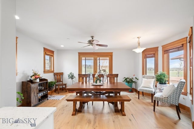 dining room with recessed lighting, plenty of natural light, and light wood-type flooring