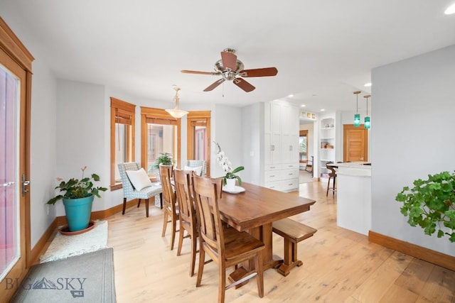 dining room featuring baseboards, a ceiling fan, light wood finished floors, and recessed lighting