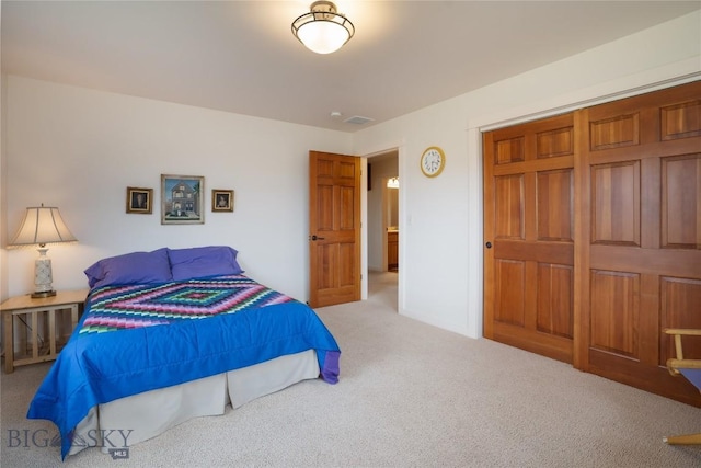 carpeted bedroom with visible vents and a closet