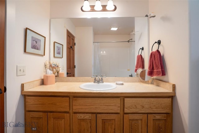 bathroom featuring vanity and a shower with shower curtain