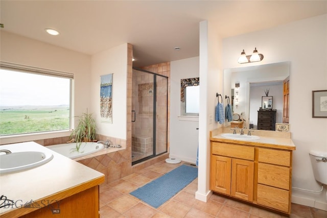 full bathroom featuring tile patterned flooring, a sink, two vanities, and a shower stall