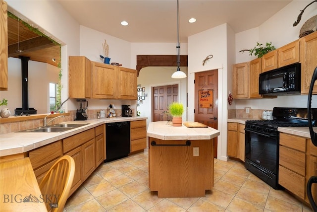 kitchen featuring a kitchen island, tile countertops, a sink, light tile patterned floors, and black appliances