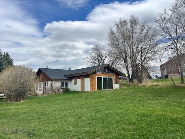 back of house with a yard and fence