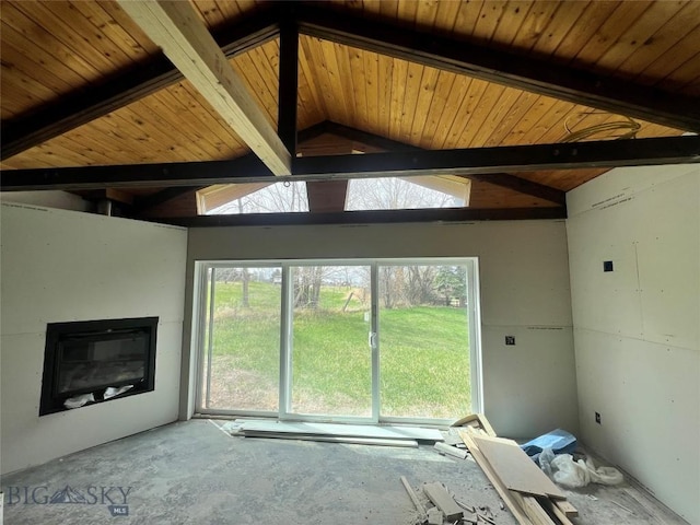 unfurnished living room with vaulted ceiling with skylight, wood ceiling, and a glass covered fireplace