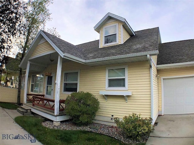 93 8th St Unit B, Belgrade, MT 59714 - view of front of house with roof with shingles, covered porch, and a garage