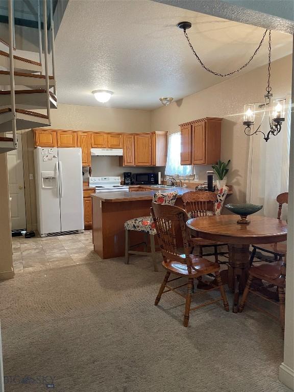 93 8th St Unit B, Belgrade, MT 59714 - dining area with a textured ceiling and a chandelier