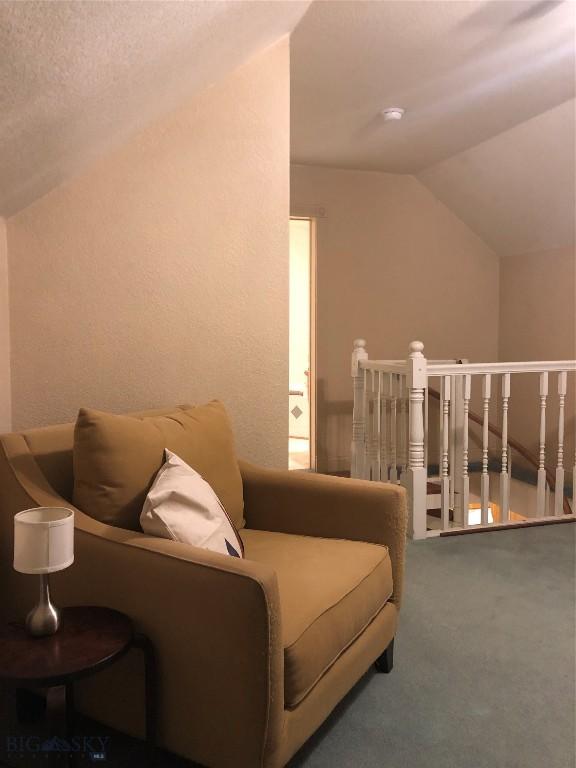 93 8th St Unit B, Belgrade, MT 59714 - living area with carpet floors and vaulted ceiling