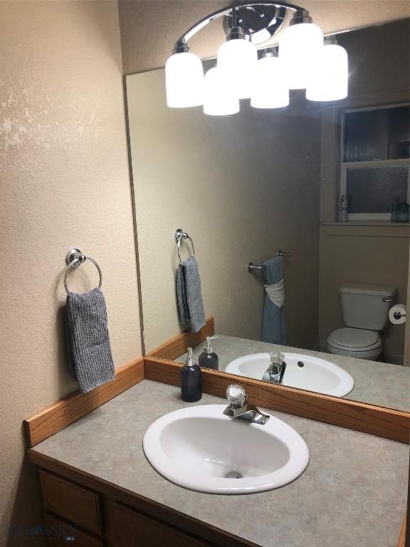 93 8th St Unit B, Belgrade, MT 59714 - bathroom with vanity and toilet
