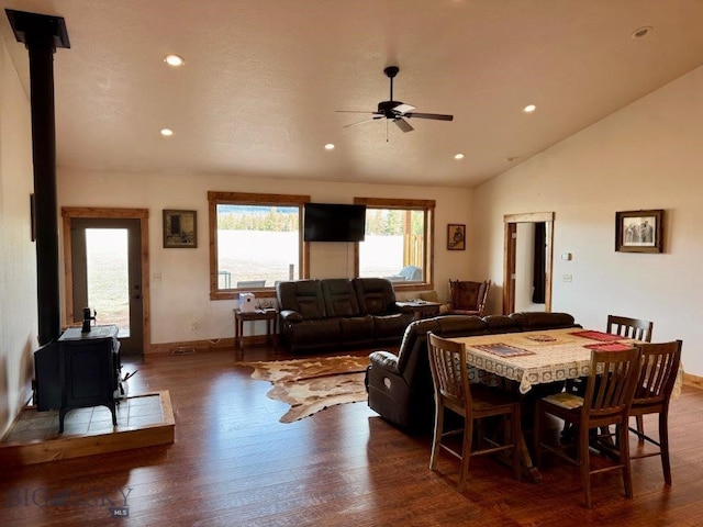 dining area featuring recessed lighting, a ceiling fan, a wood stove, and wood-type flooring