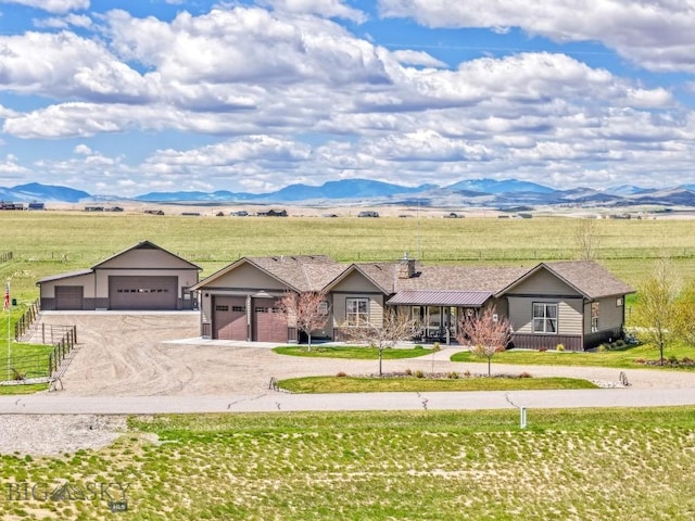 ranch-style home with dirt driveway, a mountain view, and a rural view