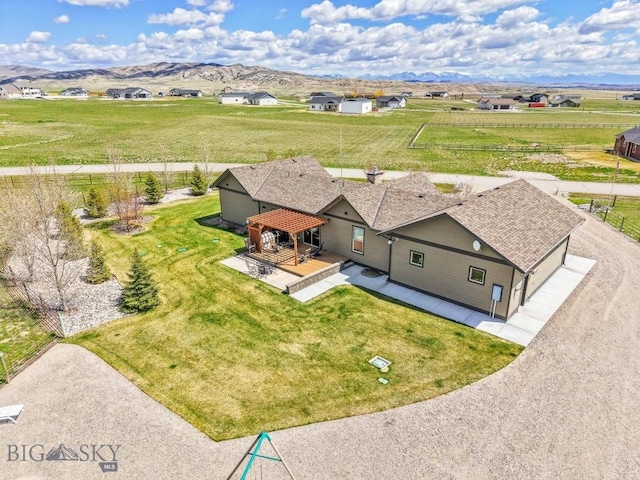birds eye view of property with a mountain view