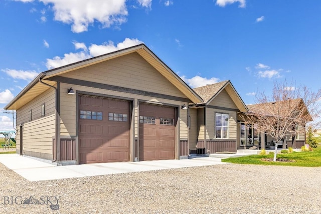 ranch-style house featuring a garage and driveway