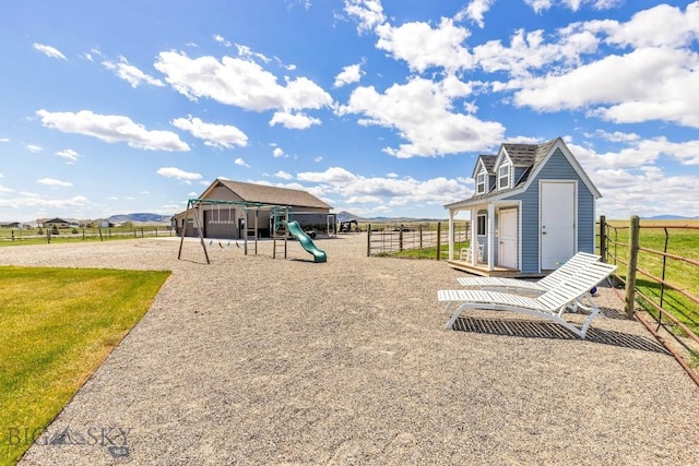 view of play area with fence and an outbuilding