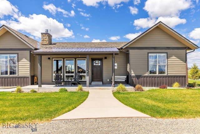 ranch-style house with a chimney and a front yard